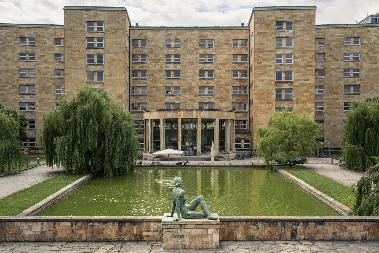 Goethe University Westend campus, with reflecting pool and bronze sculpture in the foreground.